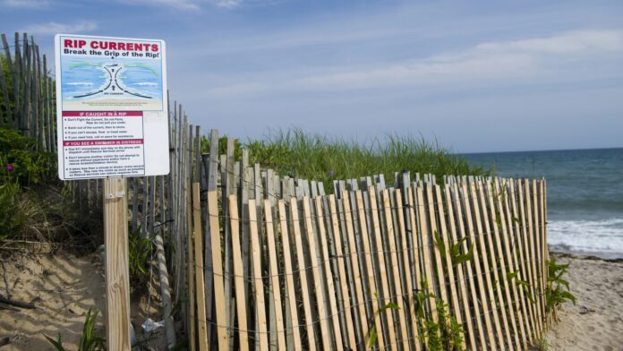 Ditch Plains beach Montauk Long Island New York in the Hamptons with rip current warning sig